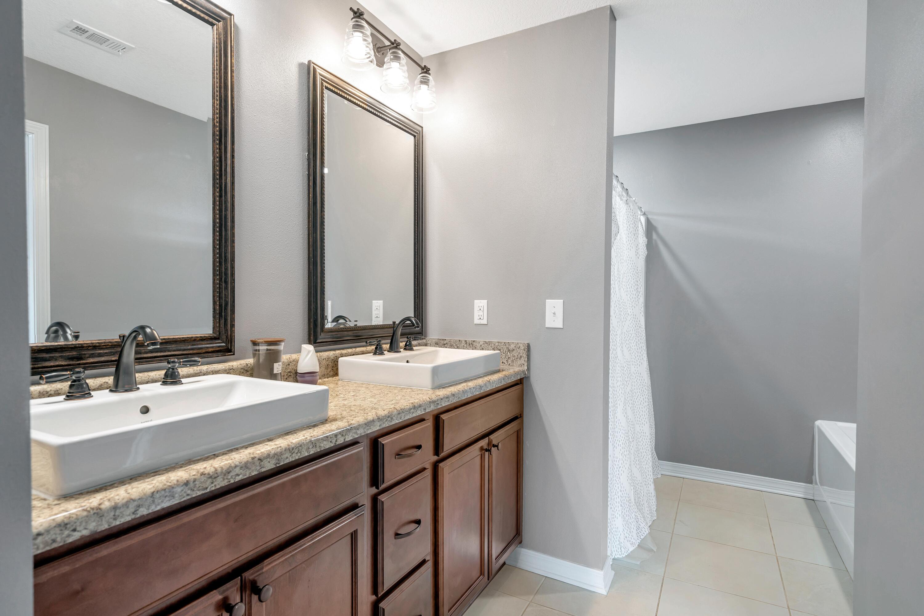 505 Eisenhower Drive Crestview, FL 32539 - Photo 29 of 39 a bathroom with a double vanity sink and a mirror