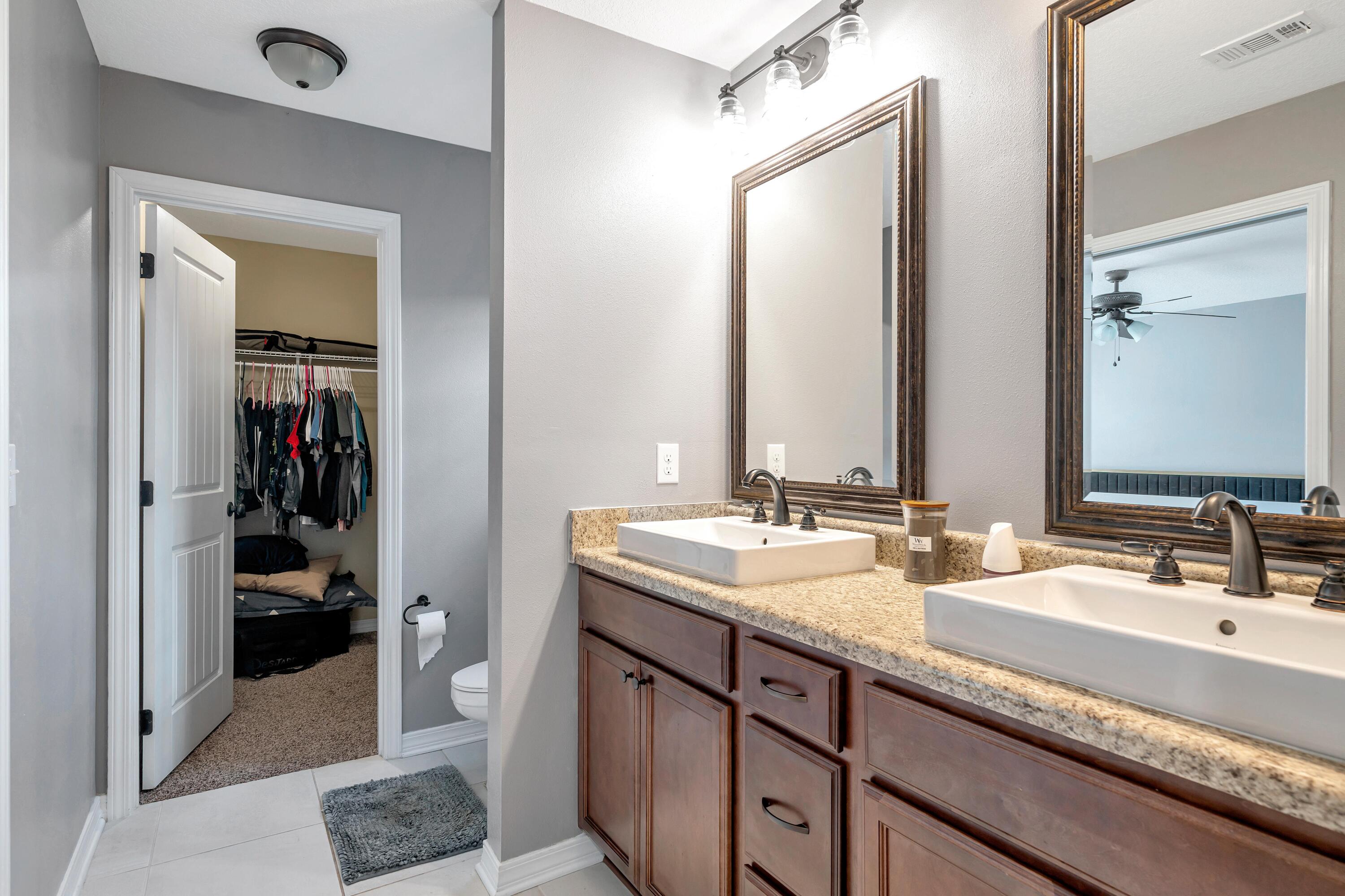 505 Eisenhower Drive Crestview, FL 32539 - Photo 31 of 39 a en suite bathroom with a double vanity sink and a mirror