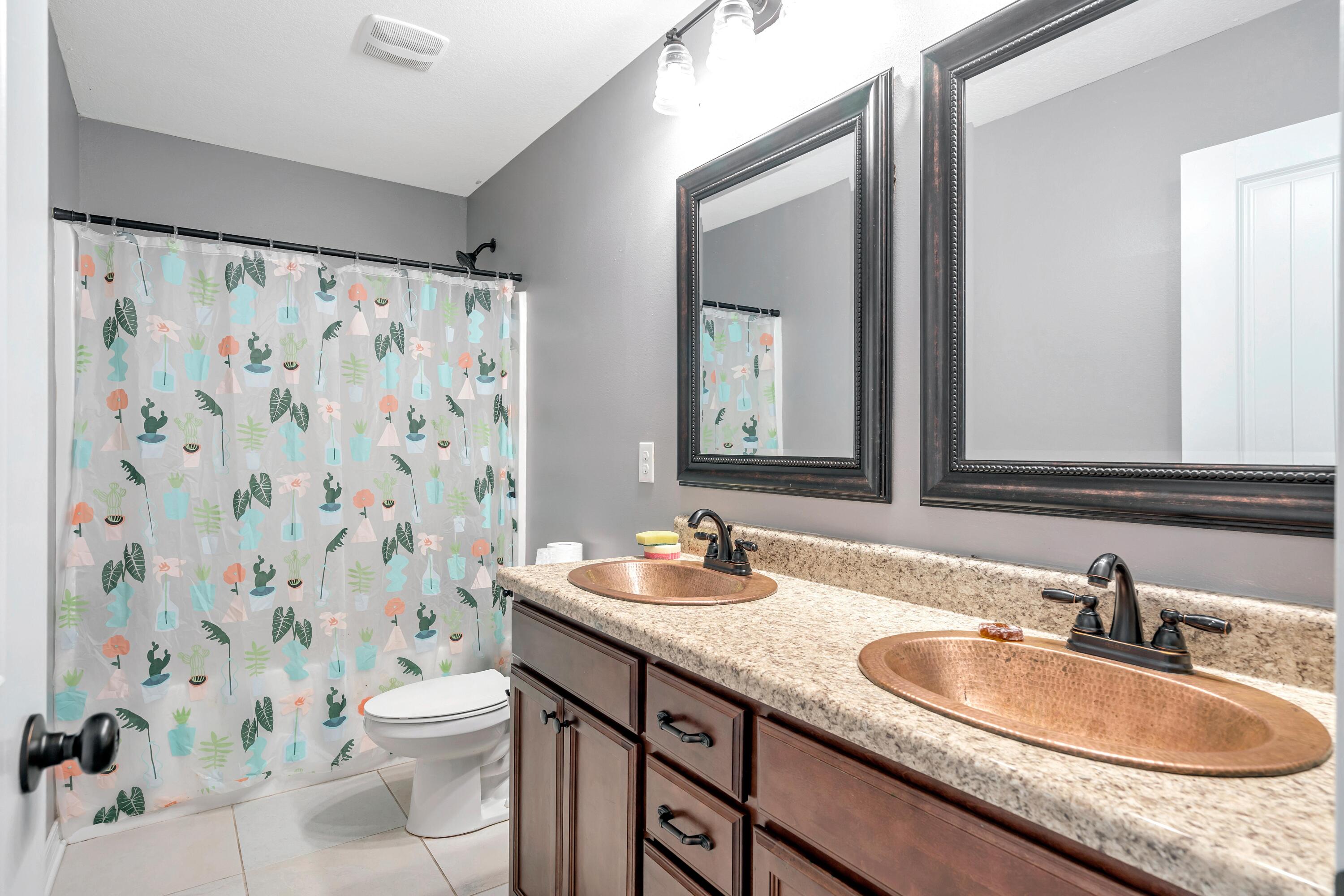 505 Eisenhower Drive Crestview, FL 32539 - Photo 33 of 39 a bathroom with a granite countertop sink and a mirror