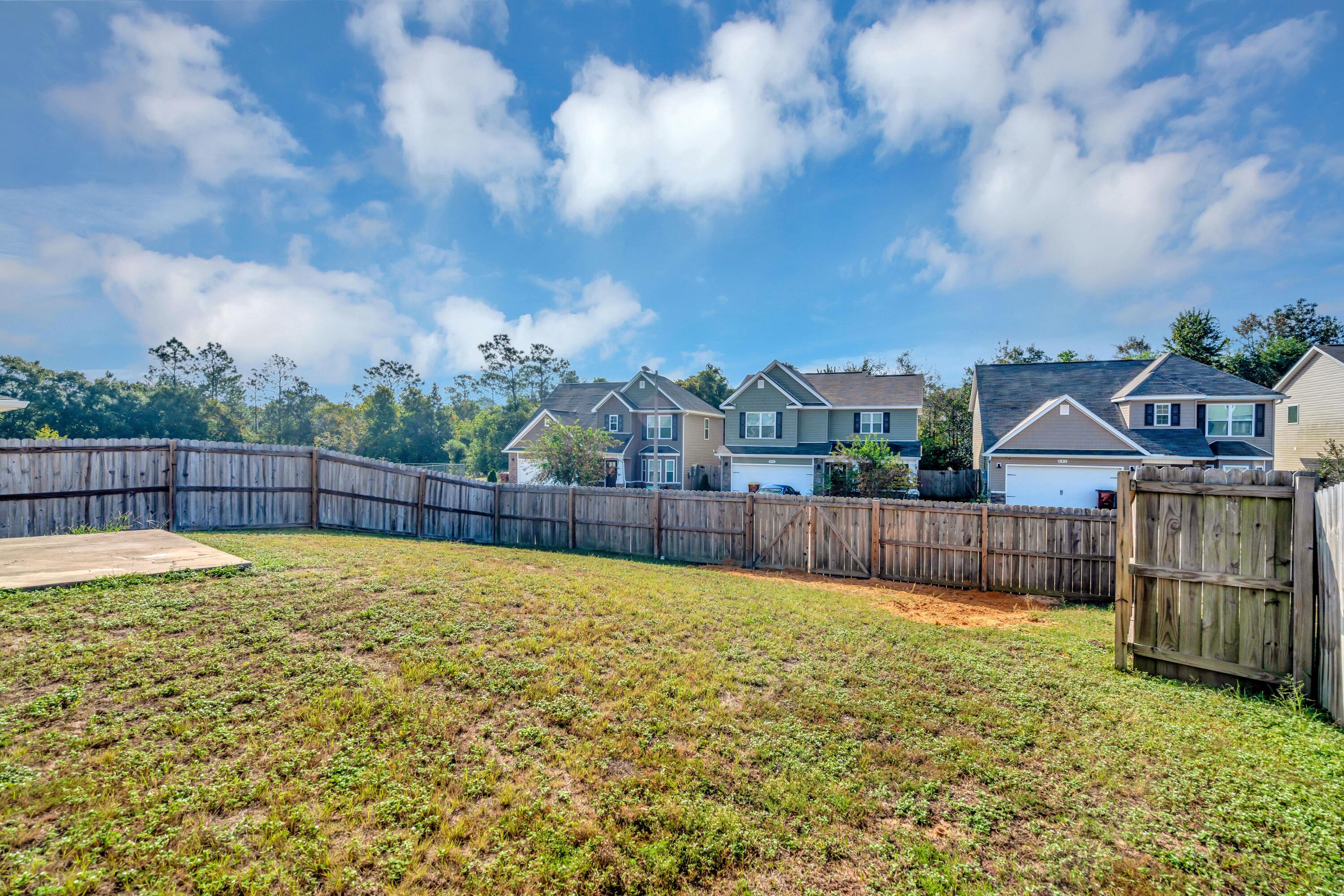 505 Eisenhower Drive Crestview, FL 32539 - Photo 36 of 39 a view of swimming pool with outdoor seating and wooden fence