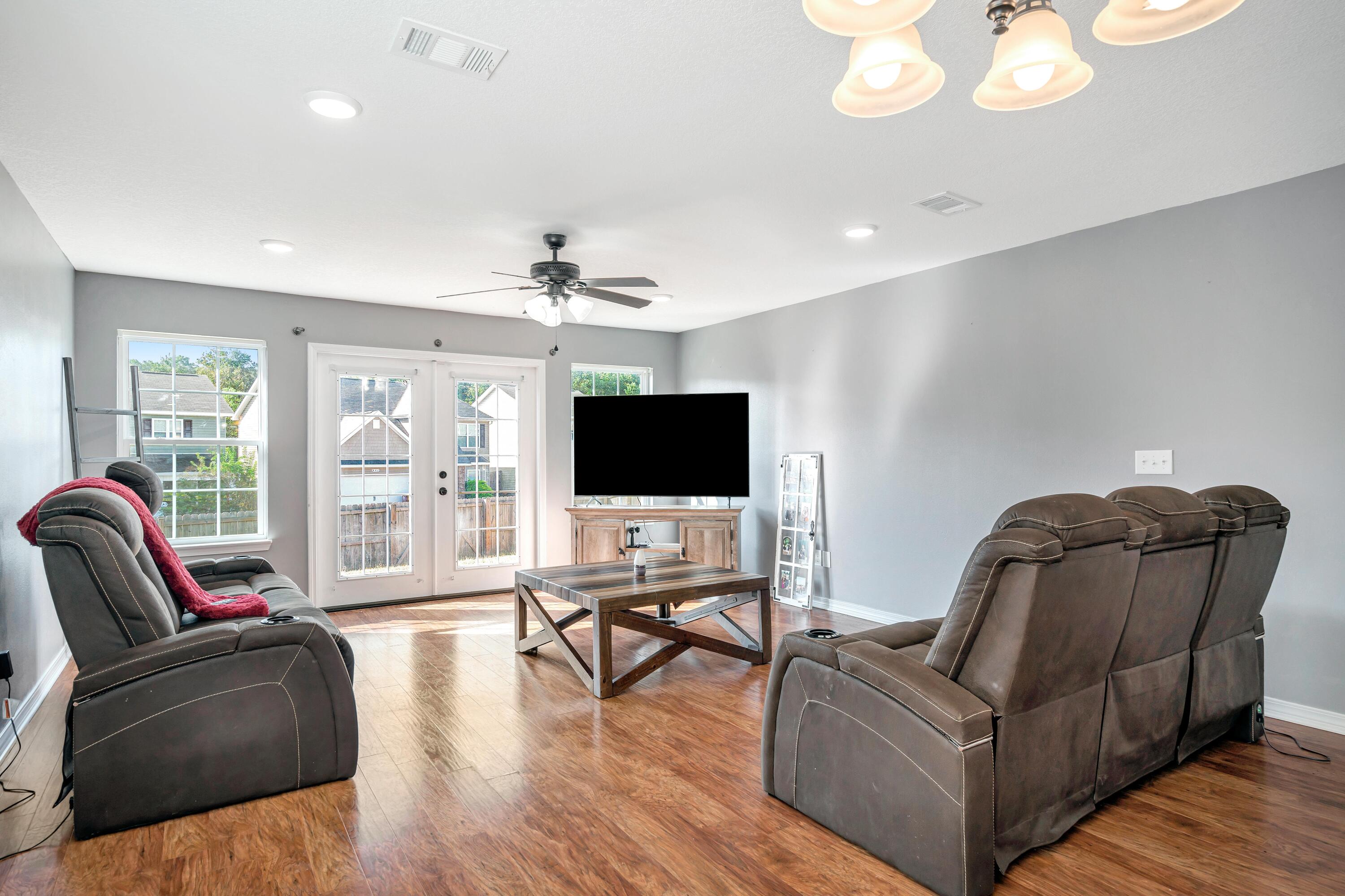 505 Eisenhower Drive Crestview, FL 32539 - Photo 6 of 39 a living room with furniture and a flat screen tv