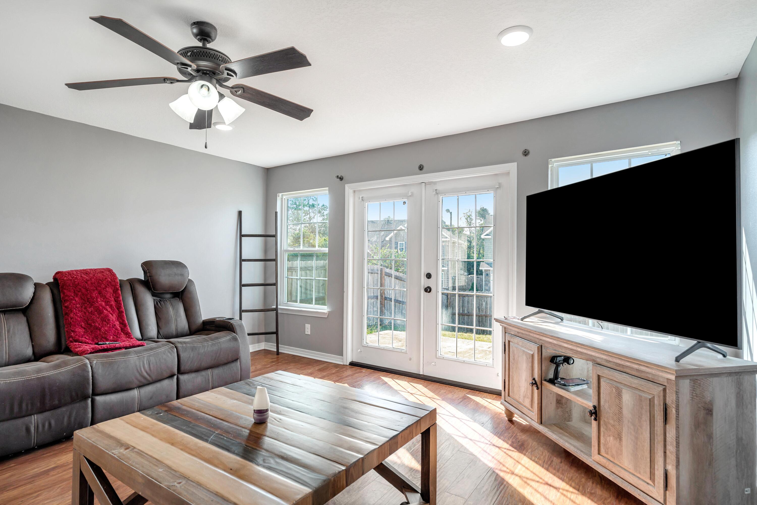 505 Eisenhower Drive Crestview, FL 32539 - Photo 9 of 39 a living room with furniture and a flat screen tv