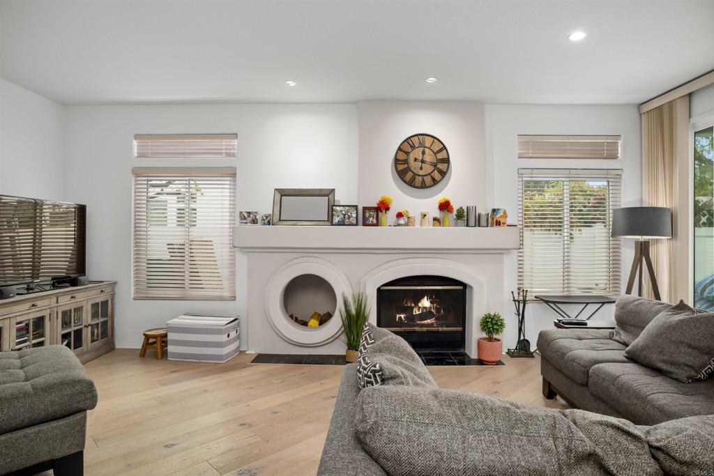 4992 Lassen Drive Oceanside, CA 92056 - Photo 11 of 27 a living room with furniture a flat screen tv and a fireplace