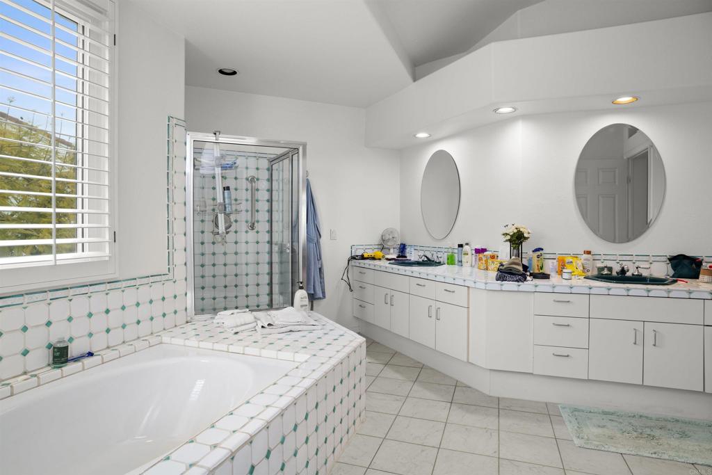4992 Lassen Drive Oceanside, CA 92056 - Photo 16 of 27 a spacious bathroom with a double vanity sink mirror and bathtub