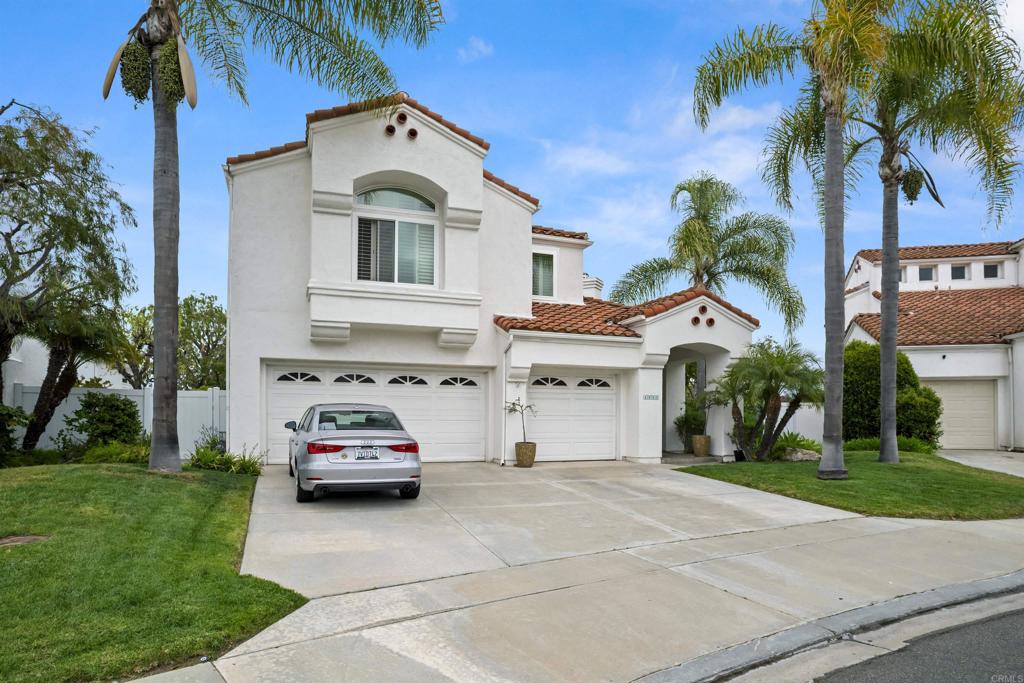 4992 Lassen Drive Oceanside, CA 92056 - Photo 2 of 27 a car parked in front of white house with a yard