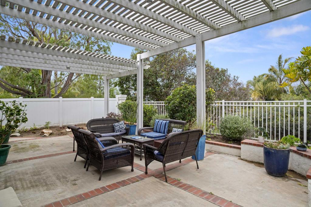 4992 Lassen Drive Oceanside, CA 92056 - Photo 22 of 27 a patio with patio couch and wooden fence