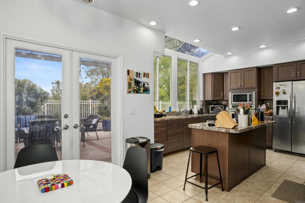 4992 Lassen Drive Oceanside, CA 92056 - Photo 8 of 27 a room with stainless steel appliances kitchen island granite countertop a dining table and chairs