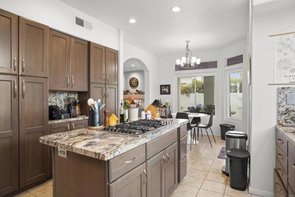 4992 Lassen Drive Oceanside, CA 92056 - Photo 9 of 27 a kitchen with granite countertop a stove refrigerator and cabinets