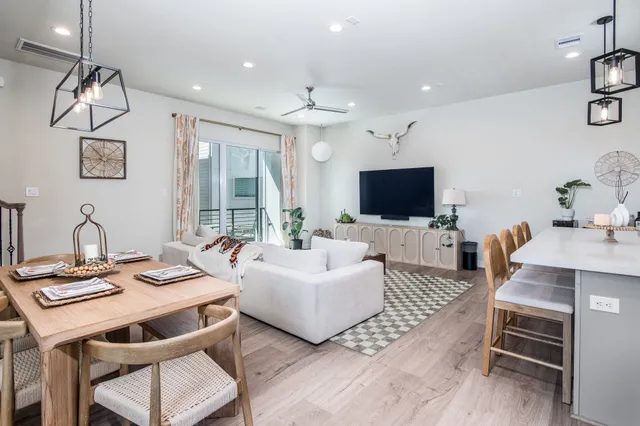 a kitchen with a sink stove and wooden floor