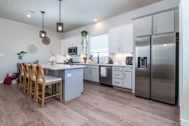 a view of a dining room with furniture and a floor to ceiling window