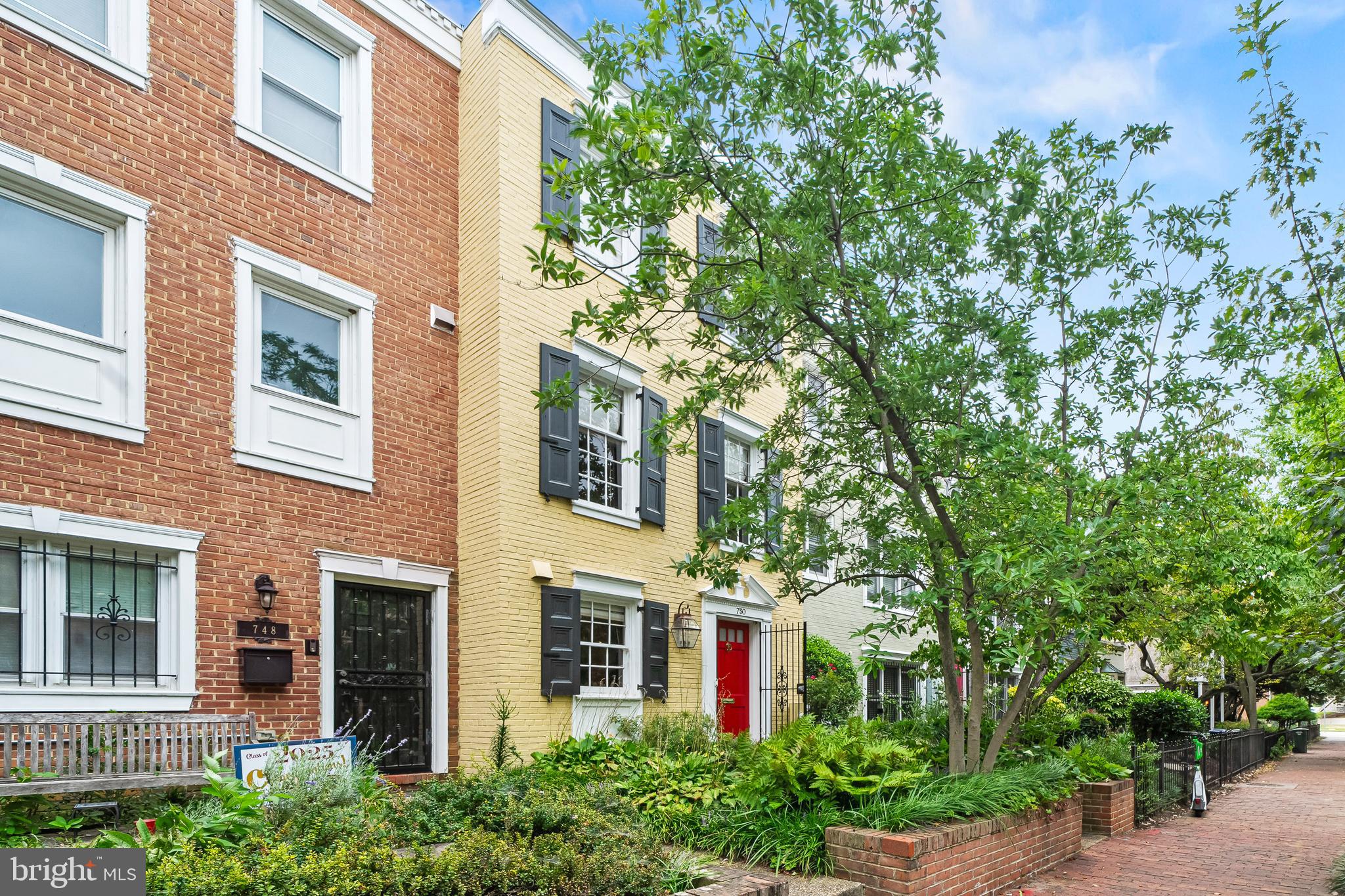 front view of a brick house with a large windows
