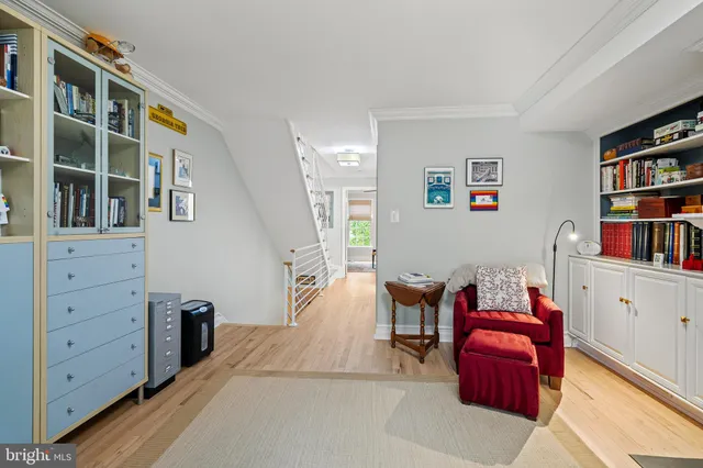 a living room with furniture and book shelf