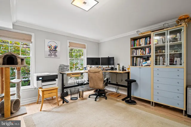 a view of a workspace with furniture and a window
