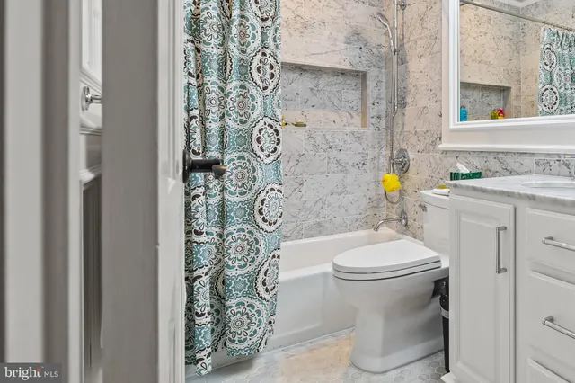 a white toilet sitting next to a bathroom sink