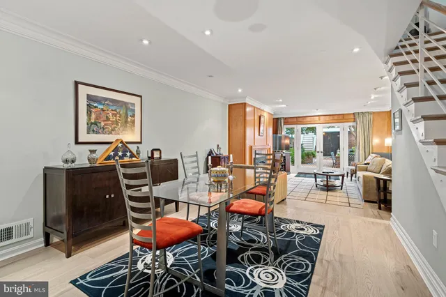 a living room with furniture a rug and a large window