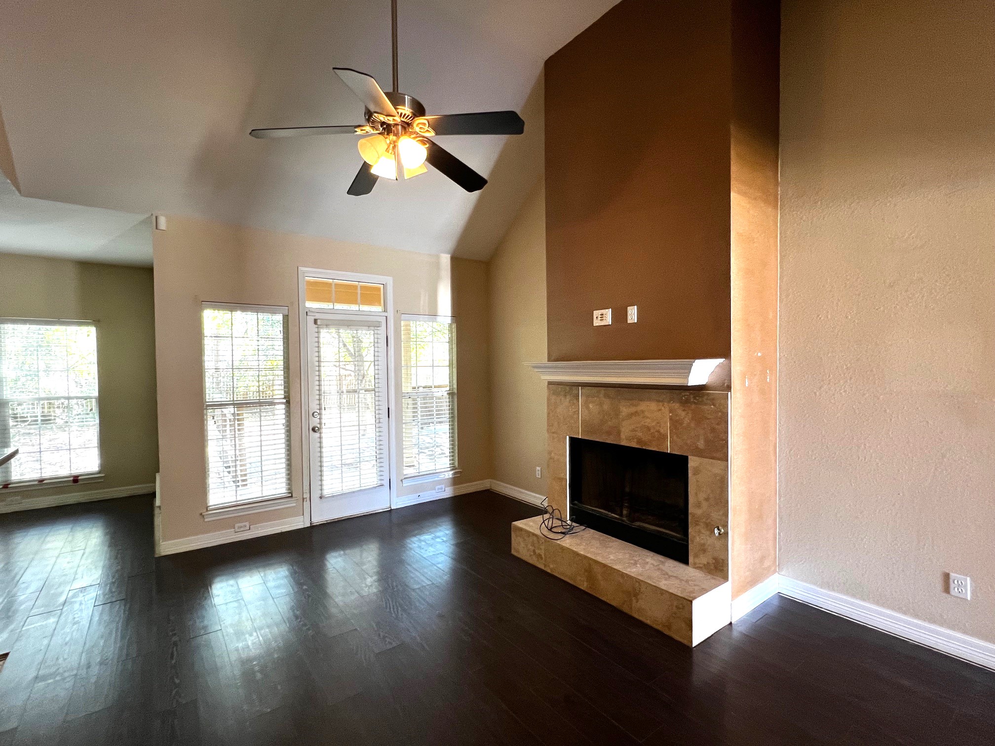 170 Rose Mayer Loop La Grange, TX 78945 - Photo 2 of 19 an empty room with wooden floor fireplace and windows