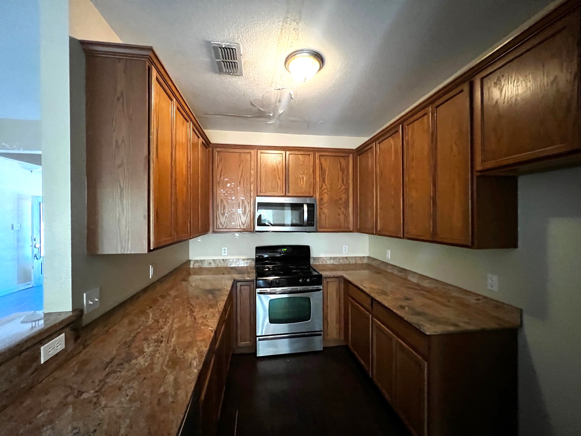170 Rose Mayer Loop La Grange, TX 78945 - Photo 3 of 19 a kitchen with stainless steel appliances granite countertop a stove a sink and a microwave