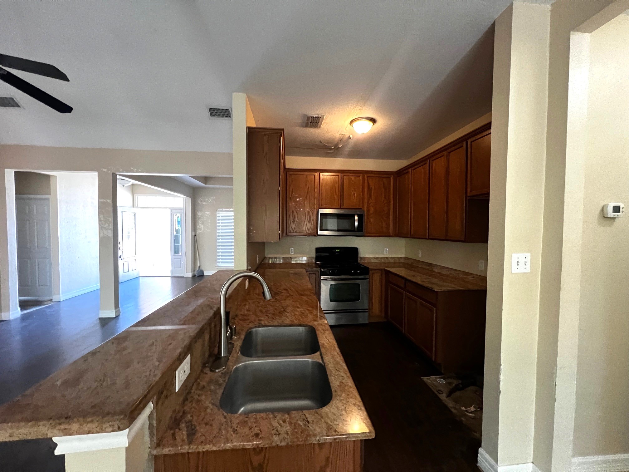 170 Rose Mayer Loop La Grange, TX 78945 - Photo 9 of 19 a kitchen with granite countertop a stove a sink and a refrigerator