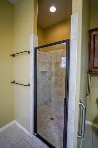 a bathroom with a glass shower door