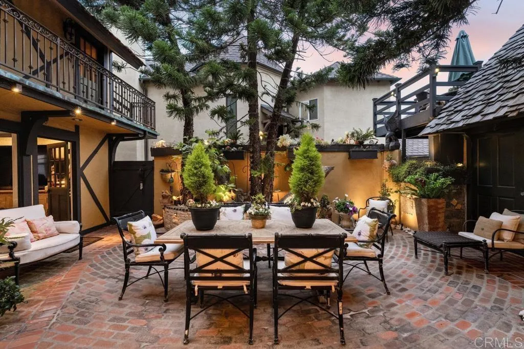 200 Neptune Avenue Encinitas, CA 92024 - Photo 11 of 33 a view of a patio with a table and chairs under an umbrella