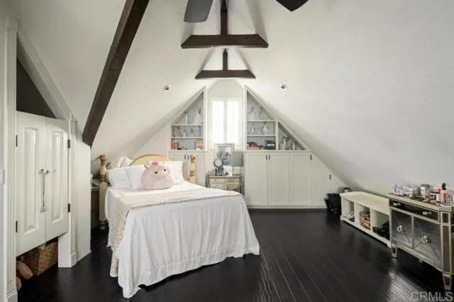 a bedroom with a bed and a book shelf