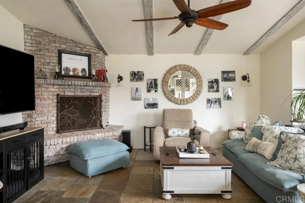 200 Neptune Avenue Encinitas, CA 92024 - Photo 31 of 33 a living room with furniture and a fireplace