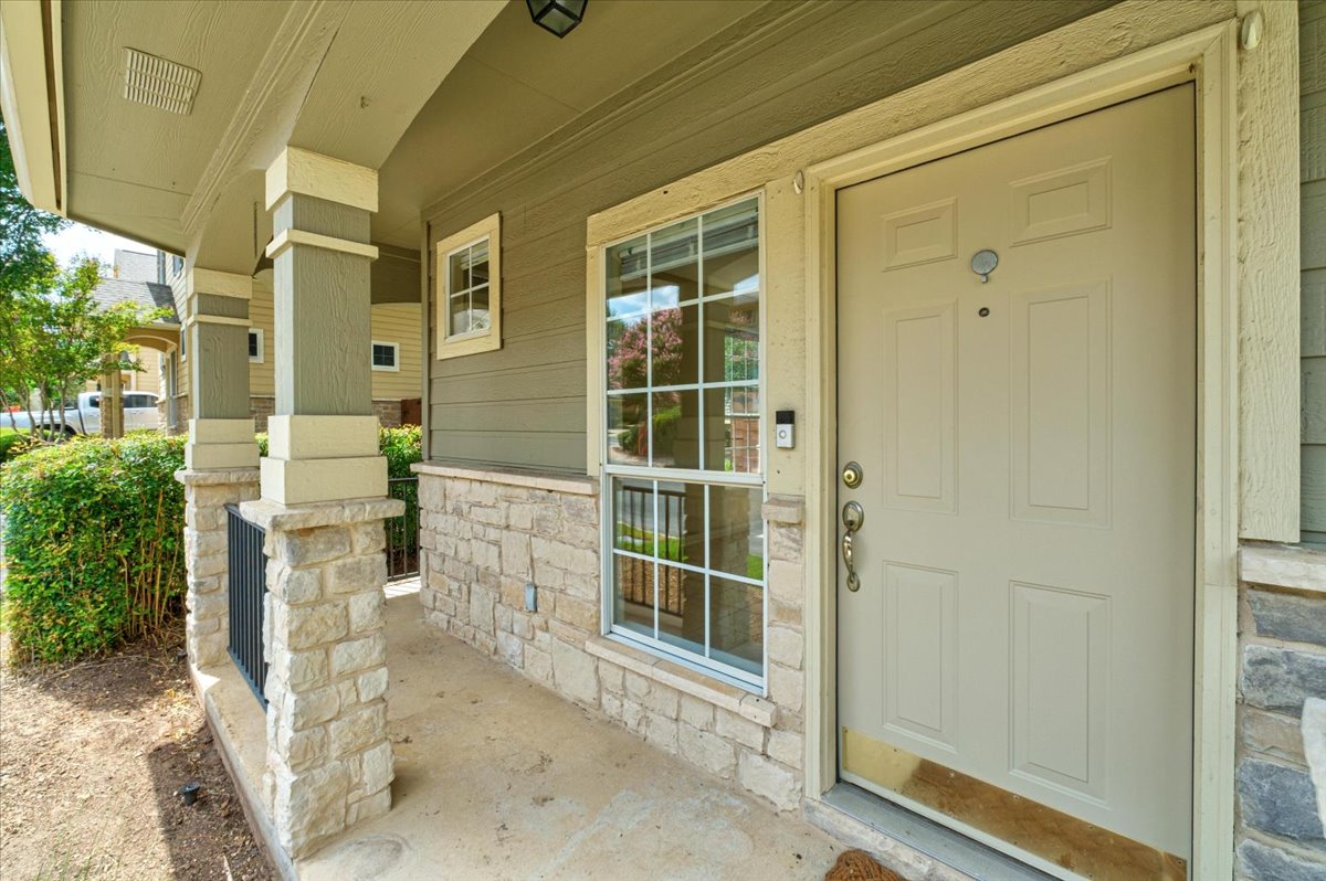11000 Anderson Mill Road, Unit 11 Austin, TX 78750 - Photo 34 of 34 A welcoming front entrance with stone accents and a covered porch.