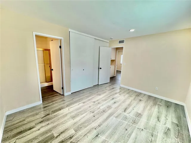 a view of an empty room and wooden floor