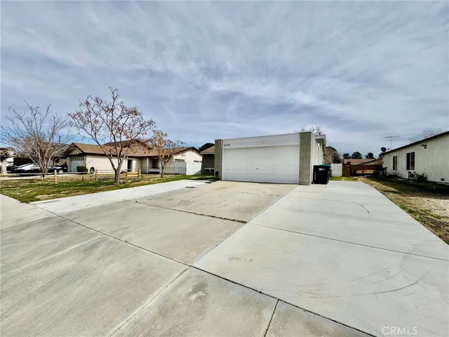 a front view of a building with cars parked