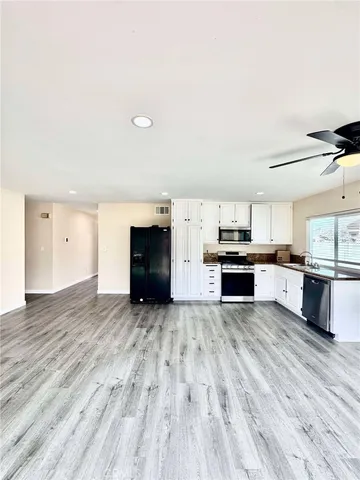 a view of kitchen with microwave and cabinets