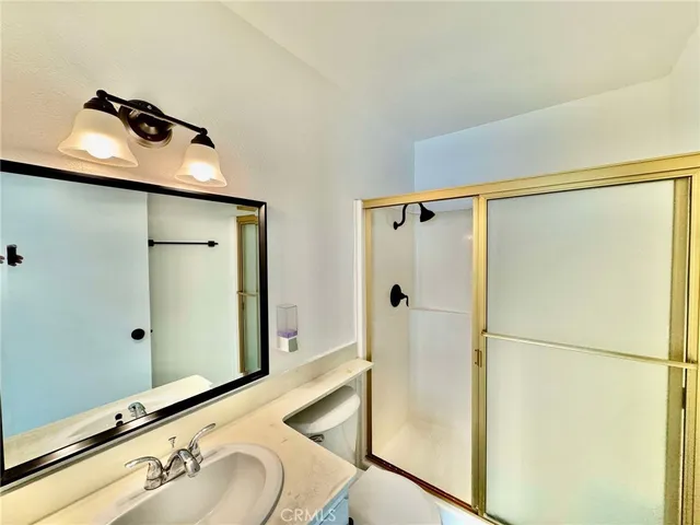 a bathroom with a shower and a sink