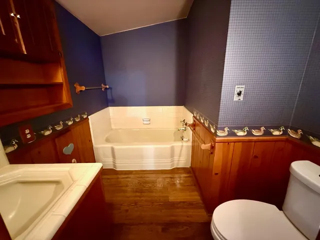 a bathroom with a sink a toilet and bathtub