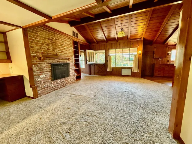 a view of empty room with a fireplace