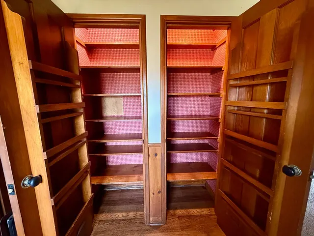 a view of walk in closet with empty racks
