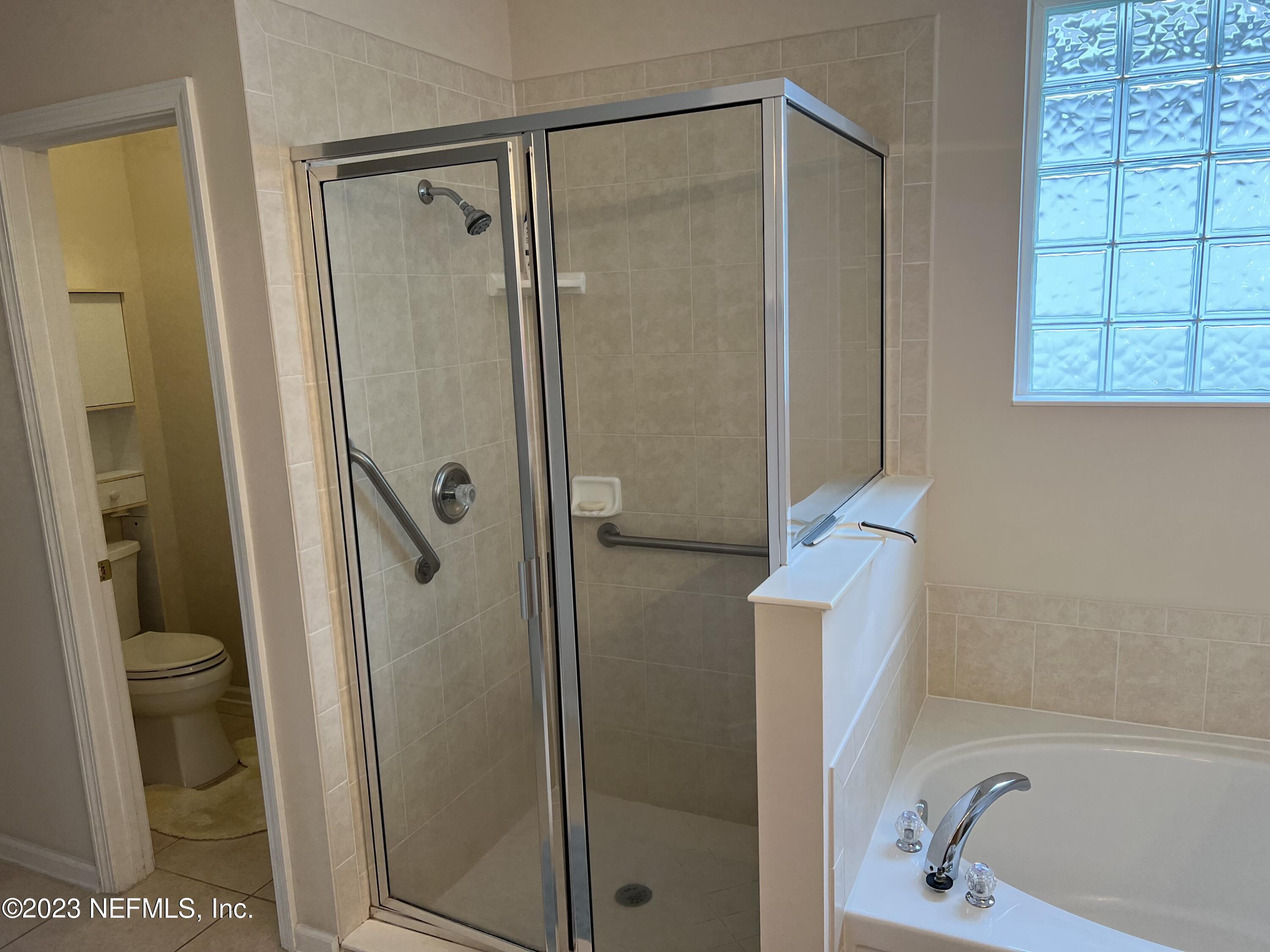 2406 Golfview Drive Fleming Island, FL 32003 - Photo 14 of 28 a bathroom with a shower and a toilet