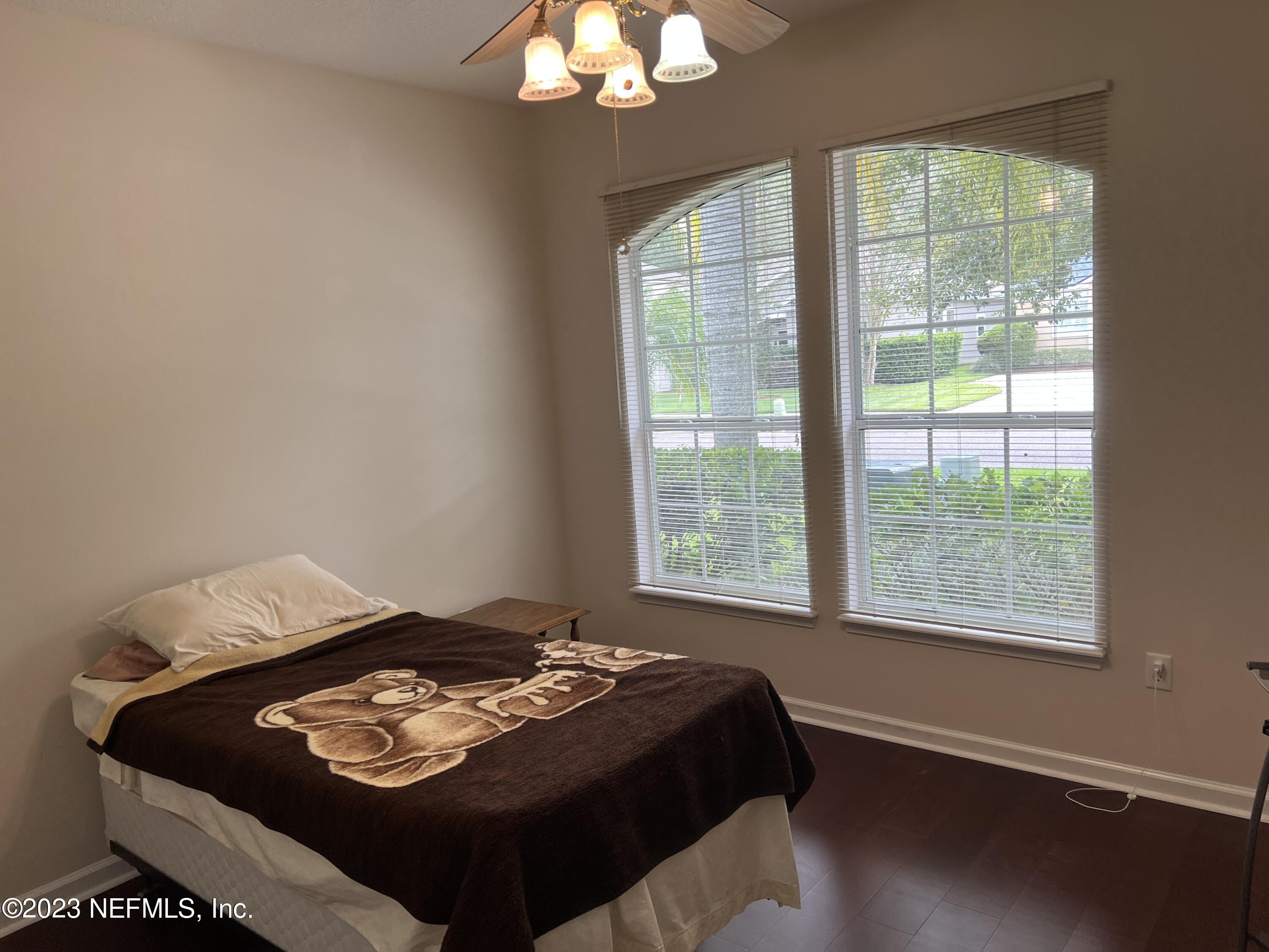 2406 Golfview Drive Fleming Island, FL 32003 - Photo 16 of 28 a bed sitting in a bedroom next to a window
