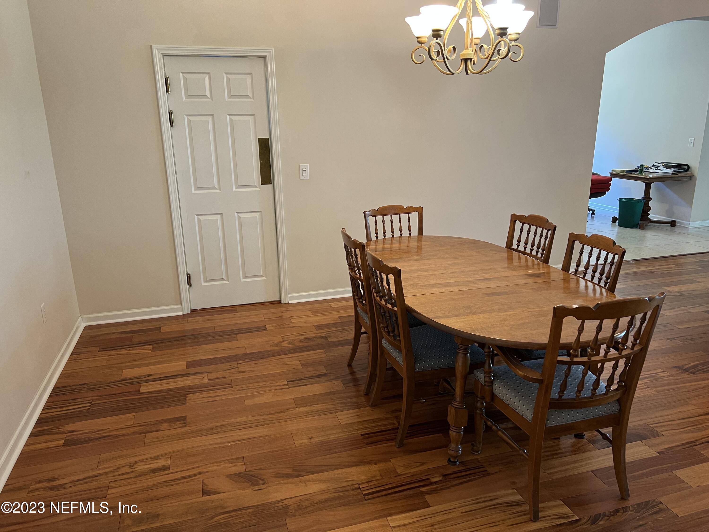 2406 Golfview Drive Fleming Island, FL 32003 - Photo 6 of 28 a view of a dining room with furniture and wooden floor