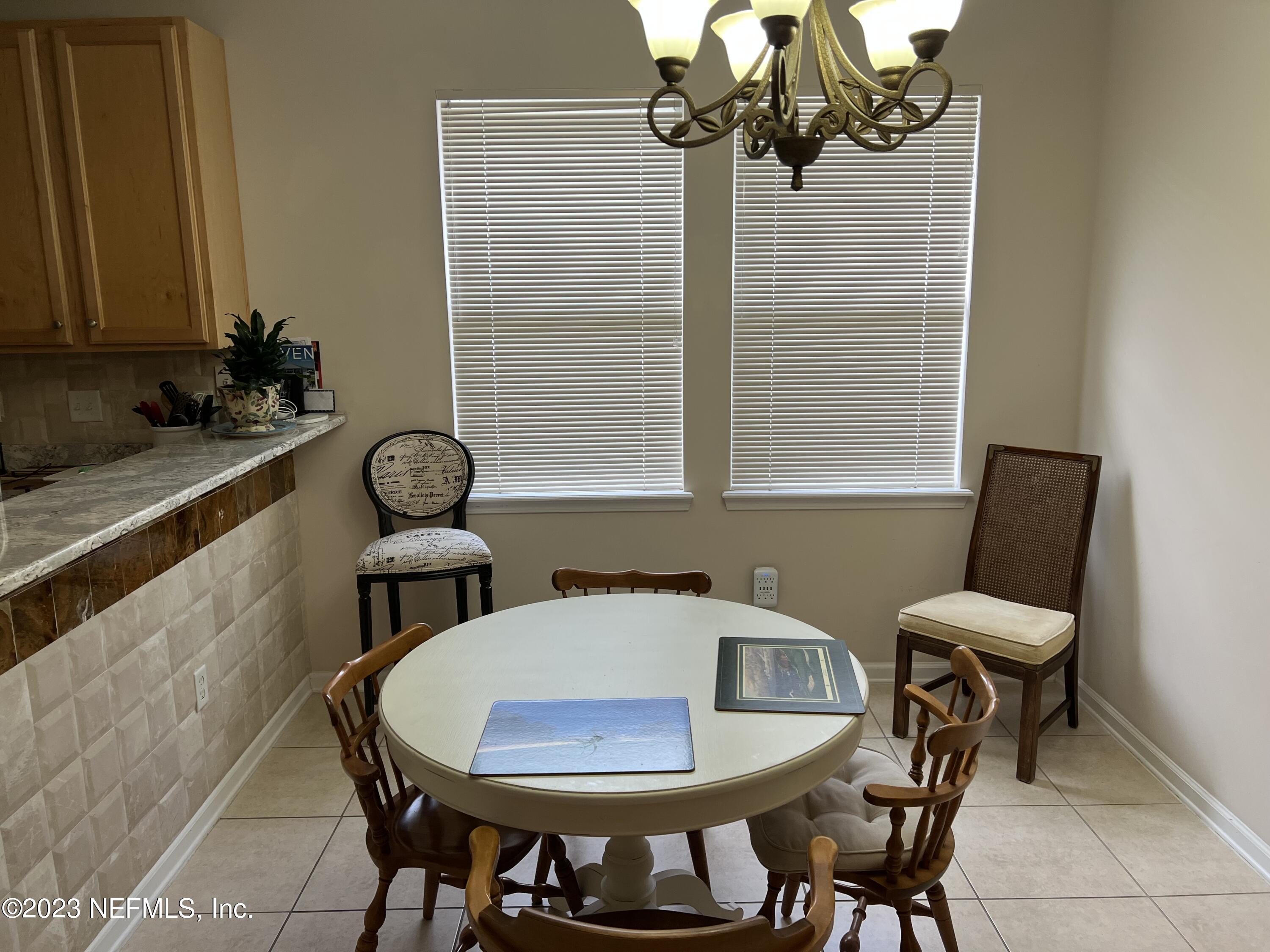 2406 Golfview Drive Fleming Island, FL 32003 - Photo 8 of 28 a view of a dining room with furniture and chandelier