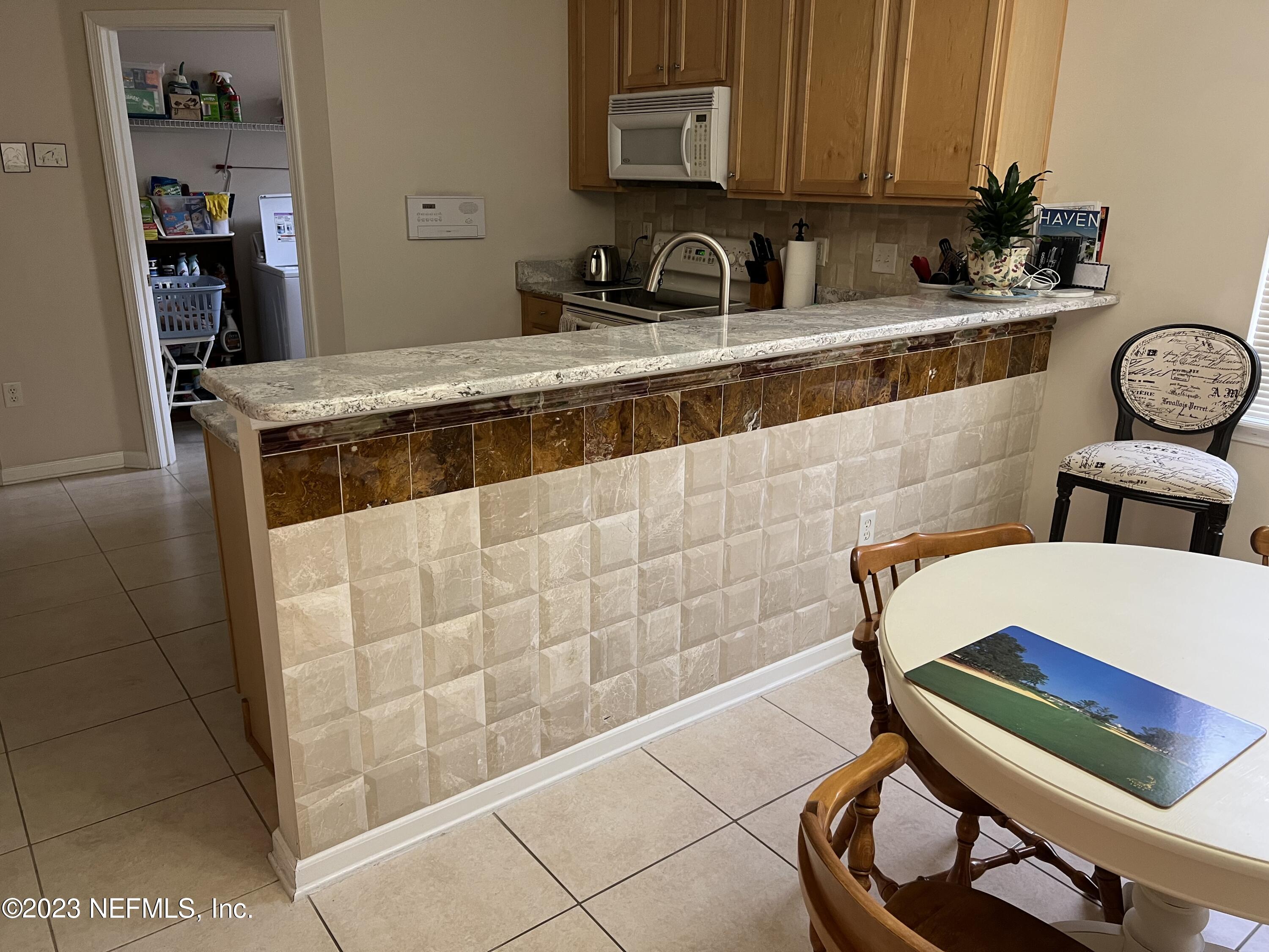 2406 Golfview Drive Fleming Island, FL 32003 - Photo 9 of 28 a kitchen with a sink cabinets and utility