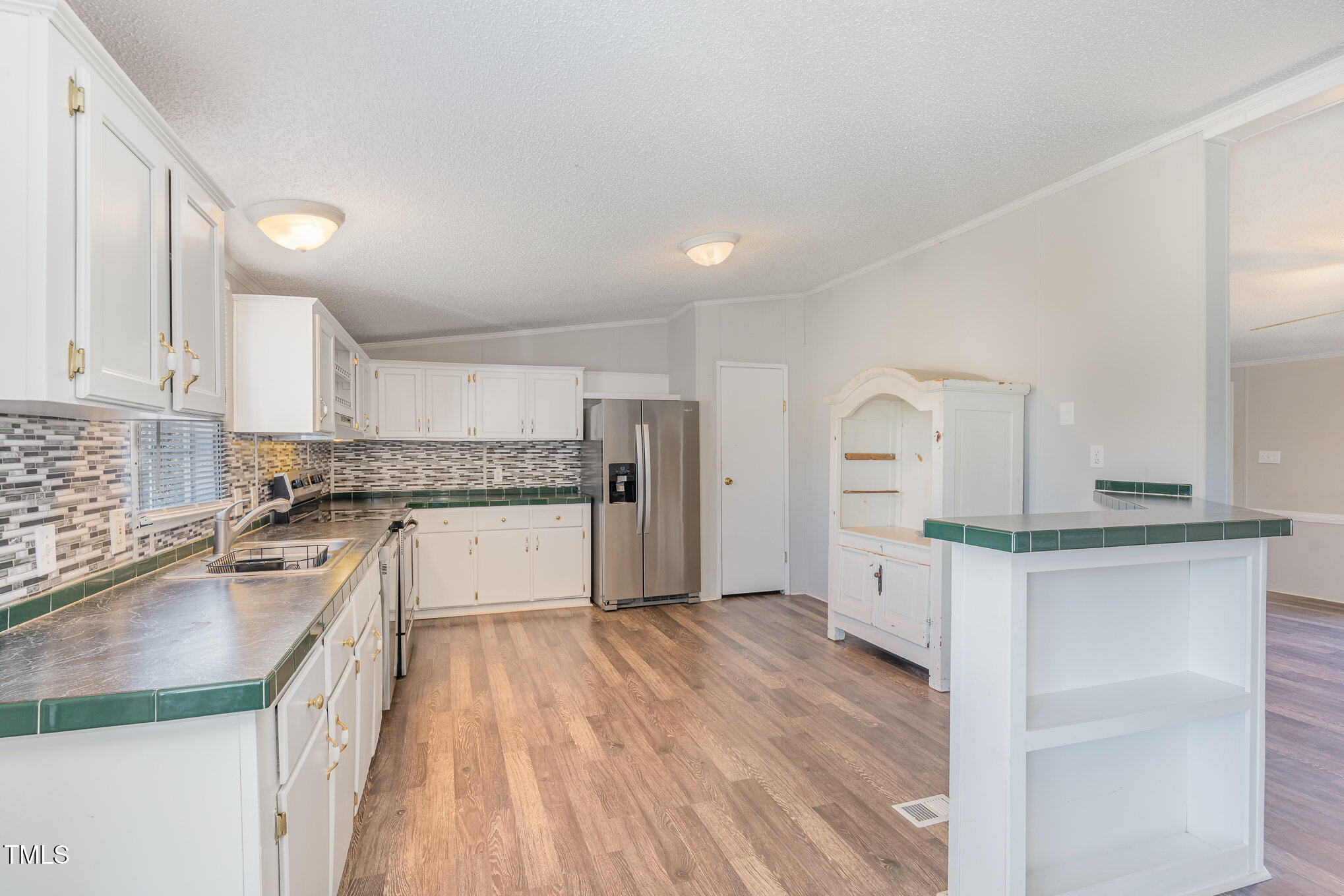 155 Kermit Duncan Road Timberlake, NC 27583 - Photo 5 of 16 a kitchen with granite countertop a sink stove and refrigerator