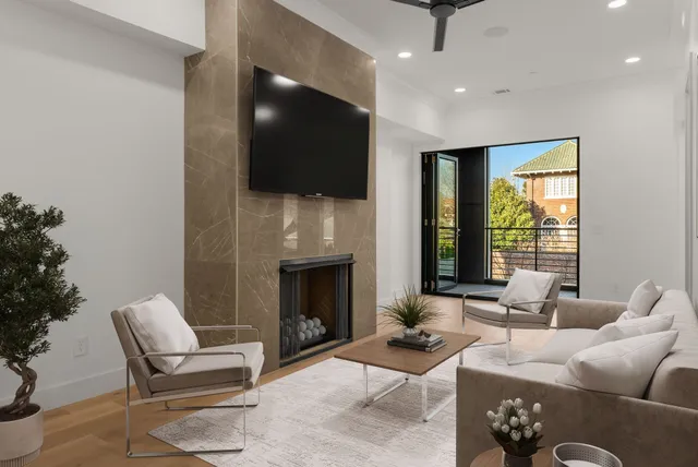 a living room with furniture a fireplace and a flat screen tv