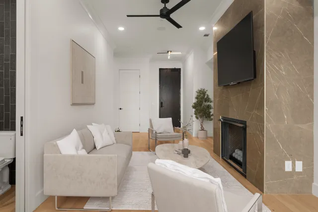 a living room with furniture a fireplace and a flat screen tv