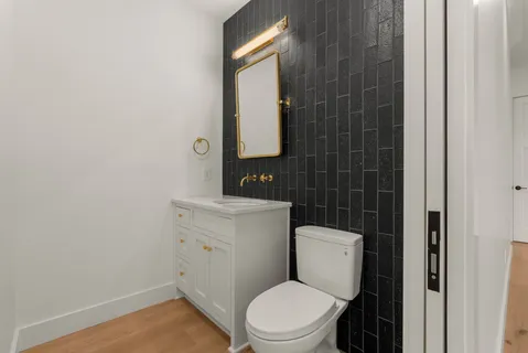 a white toilet sitting next to a bathroom sink