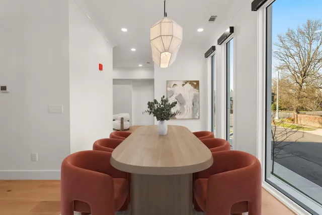 a dining room with furniture and wooden floor