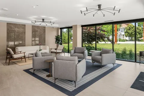 a living room with furniture and a chandelier