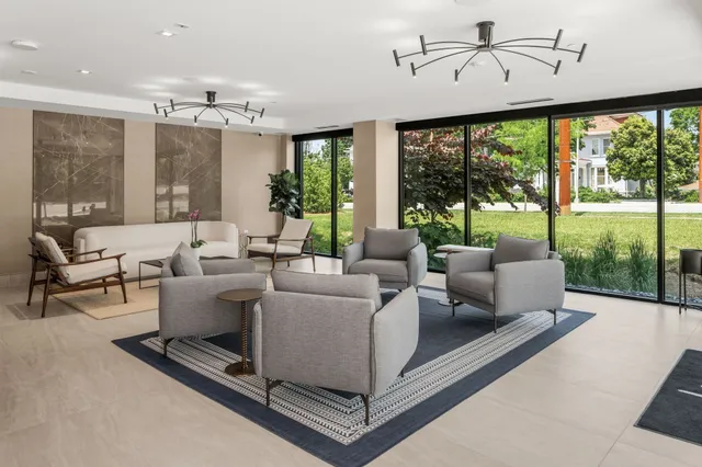 a living room with furniture and a chandelier