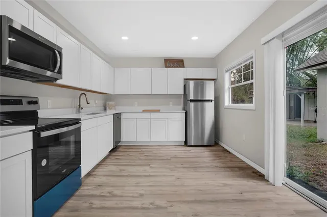 a kitchen with a sink stainless steel appliances and cabinets