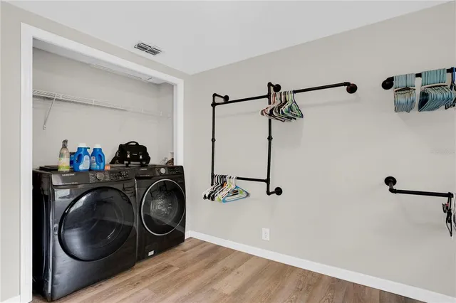 a utility room with sink dryer and washer