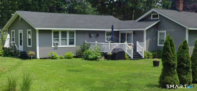a front view of a house with a garden and porch