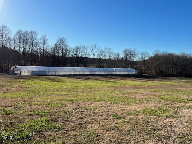 971 Rock Spring Church Road Henderson, NC 27537 - Photo 38 of 39 a view of a swimming pool and trees in the background